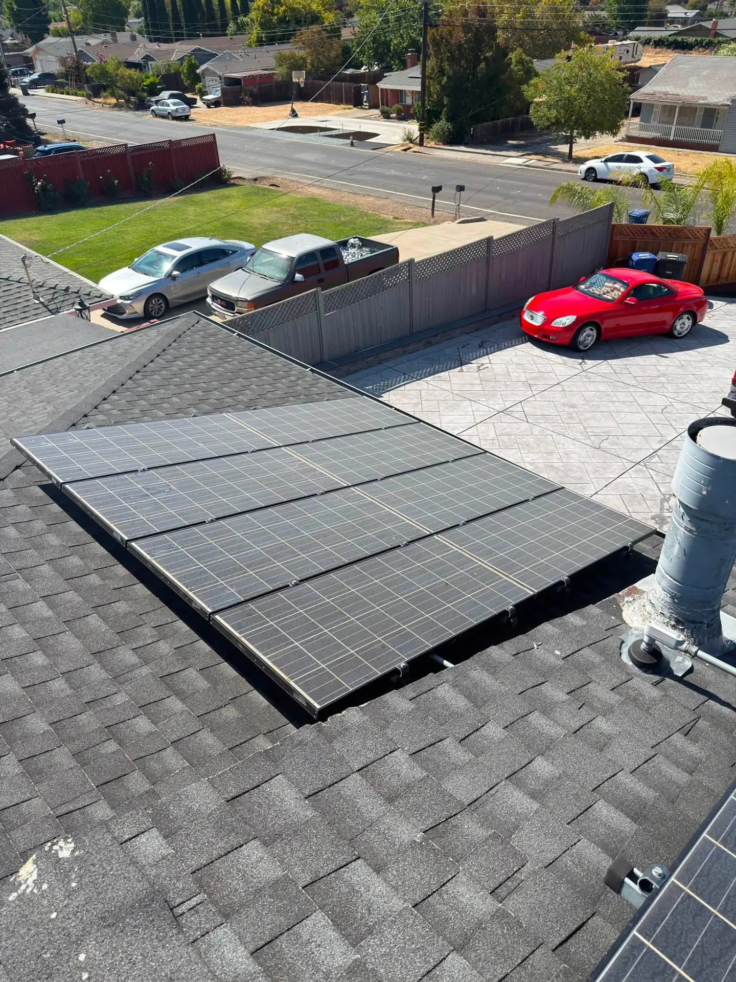 Roof-mounted solar panels cleaned above a driveway